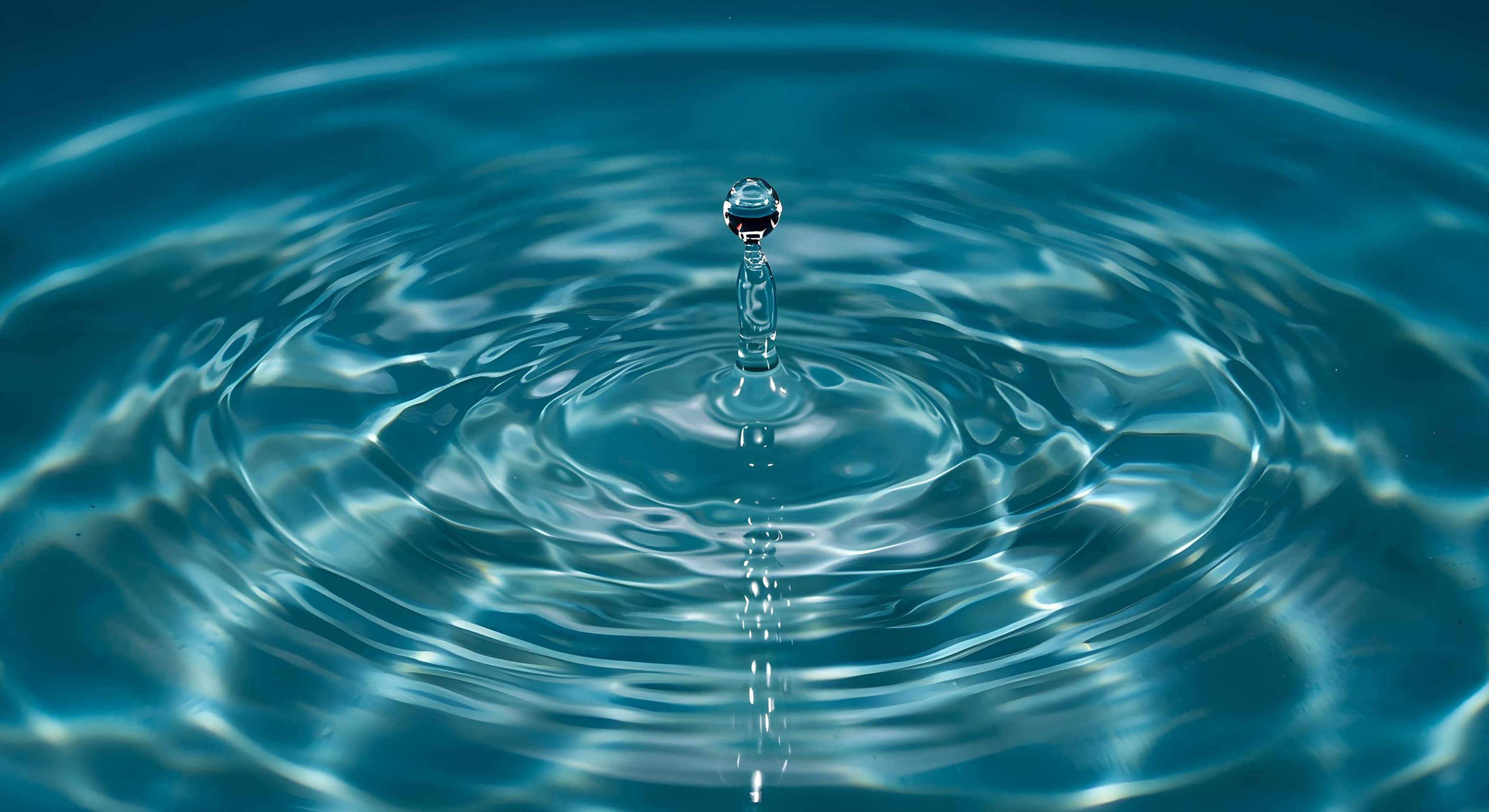 Minimal blue water surface with clear sky - clean water representation